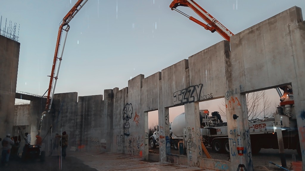 Residential concrete pumping over a home